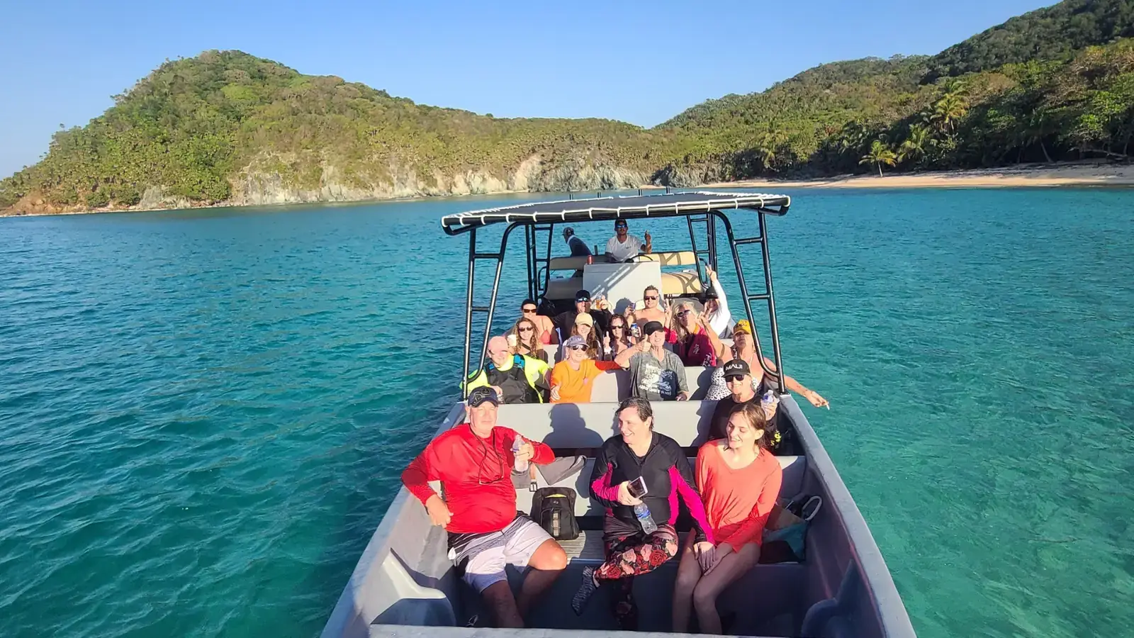 MDesktop A boat full of happy people with Jade Beach Barbareta Island in the Background
