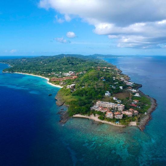 The Ultimate Guide to Roatan, Honduras - Roatan Day Tours 2 The pristine white sands and clear blue water of West Bay Beach, a popular spot for visitors.